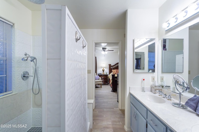21 Kachina, Rio Rico, AZ 85648 - ensuite bathroom featuring a ceiling fan, wood finished floors, a walk in shower, vanity, and ensuite bathroom