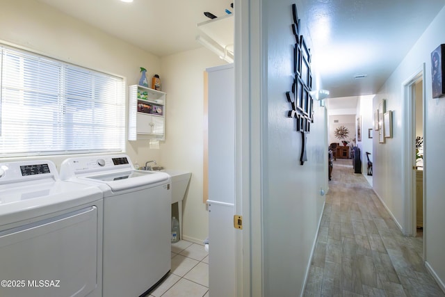 21 Kachina, Rio Rico, AZ 85648 - laundry room featuring laundry area, washer and clothes dryer, baseboards, and light wood-style floors