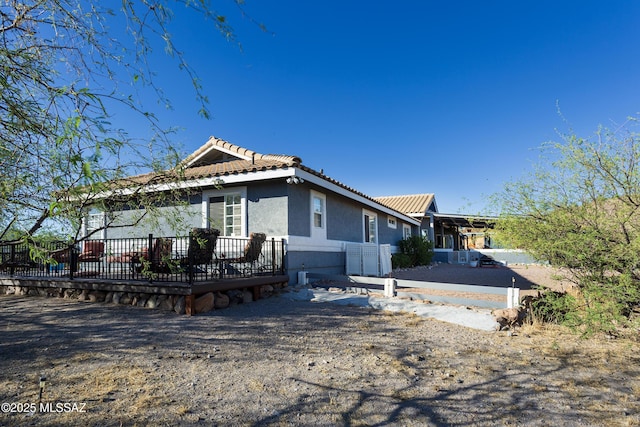 21 Kachina, Rio Rico, AZ 85648 - view of side of home featuring a wooden deck, stucco siding, and a tile roof