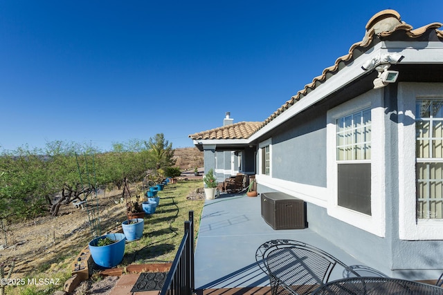 21 Kachina, Rio Rico, AZ 85648 - exterior space featuring a patio, stucco siding, a chimney, and a tiled roof