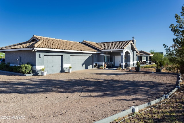 21 Kachina, Rio Rico, AZ 85648 - view of front of house with stucco siding, an attached garage, driveway, and a tile roof