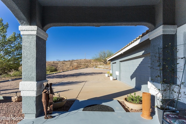 21 Kachina, Rio Rico, AZ 85648 - view of patio / terrace featuring driveway and a garage