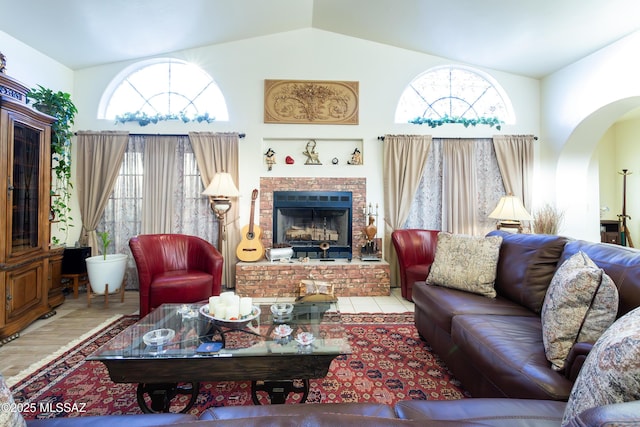 21 Kachina, Rio Rico, AZ 85648 - living room featuring arched walkways, a fireplace, vaulted ceiling, and a wealth of natural light