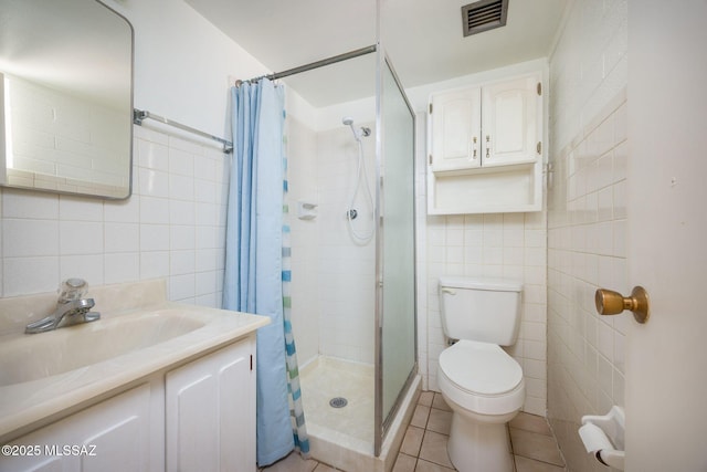 390 N Silverbell Rd, Tucson, AZ 85745 - bathroom featuring tile walls, a stall shower, toilet, vanity, and tile patterned floors