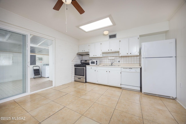 390 N Silverbell Rd, Tucson, AZ 85745 - kitchen featuring white appliances, washer / clothes dryer, a sink, light countertops, and light tile patterned flooring
