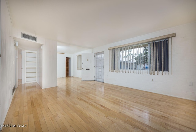 390 N Silverbell Rd, Tucson, AZ 85745 - unfurnished living room featuring light wood-style flooring