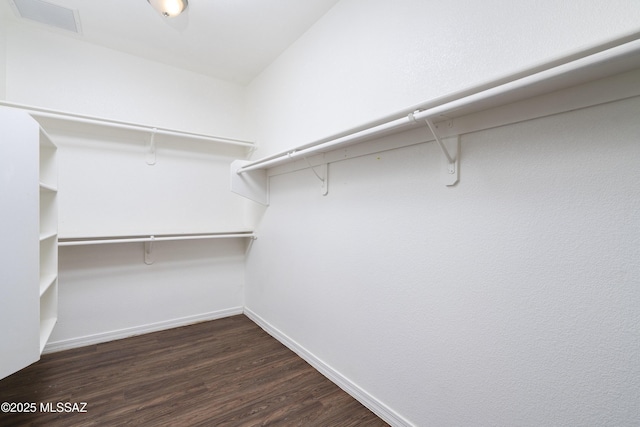 spacious closet featuring dark wood-style floors and visible vents
