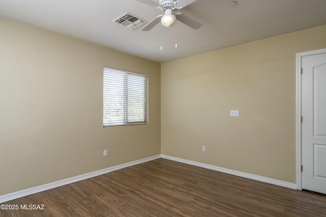 unfurnished room featuring visible vents, dark wood-style flooring, ceiling fan, and baseboards