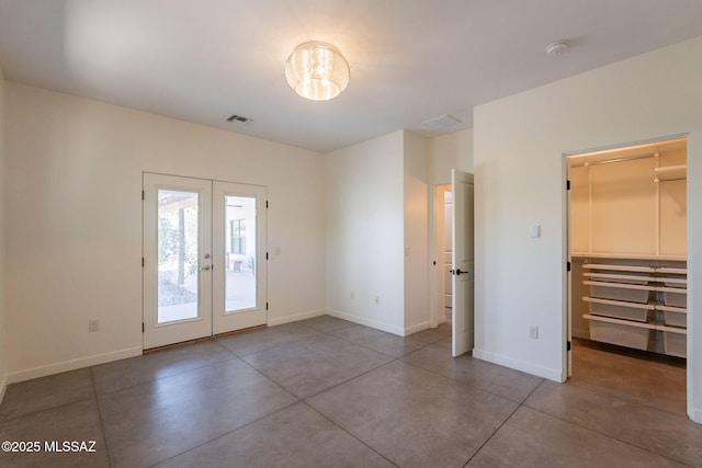 entryway with baseboards, visible vents, french doors, and finished concrete flooring