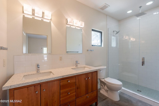 full bath with a sink, a shower stall, and toilet