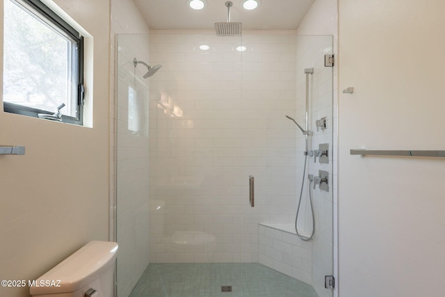 bathroom featuring recessed lighting, a stall shower, and toilet