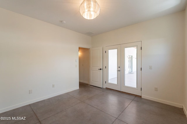 interior space featuring concrete flooring, baseboards, and french doors