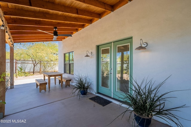 view of patio / terrace featuring ceiling fan, fence, and french doors