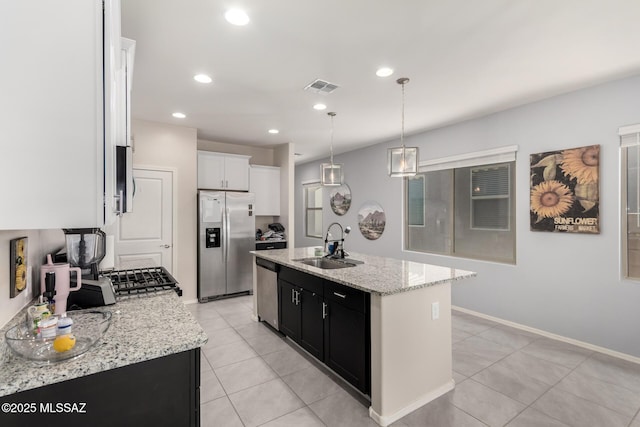7688 S Via Perfecta, Tucson, AZ 85756 - kitchen featuring stainless steel appliances, a sink, an island with sink, light tile patterned floors, and pendant lighting