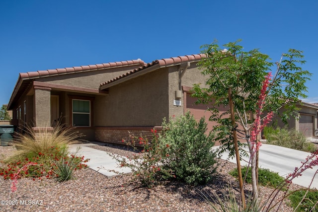 7688 S Via Perfecta, Tucson, AZ 85756 - view of home's exterior with stucco siding and a tiled roof