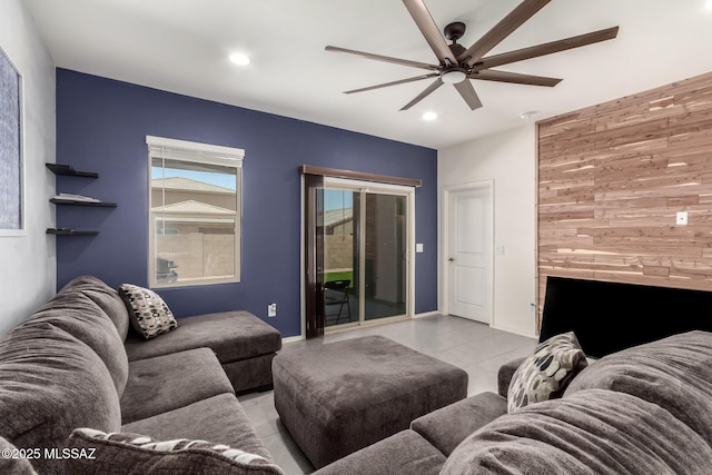 7688 S Via Perfecta, Tucson, AZ 85756 - living room featuring ceiling fan, recessed lighting, wooden walls, light tile patterned floors, and an accent wall