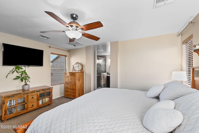 carpeted bedroom with visible vents, ceiling fan, and ensuite bath