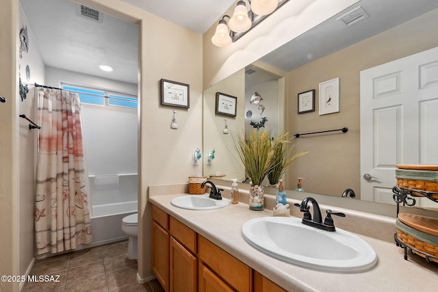 full bathroom with toilet, visible vents, and a sink