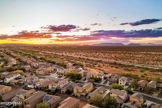 aerial view at dusk with a mountain view and a residential view
