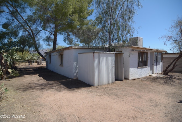 view of outbuilding featuring fence