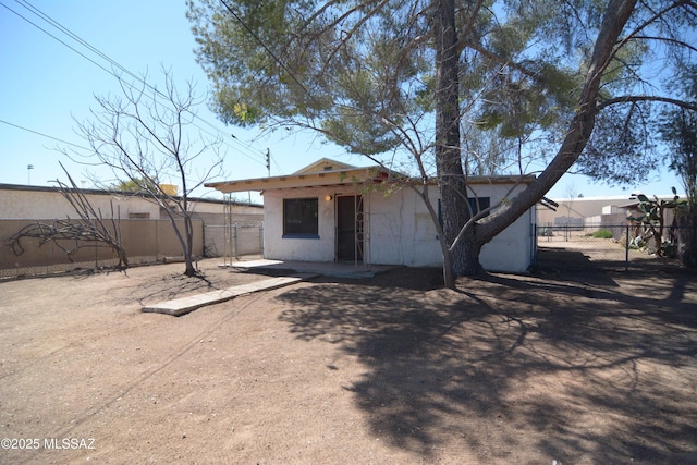 exterior space featuring fence, a patio area, and stucco siding