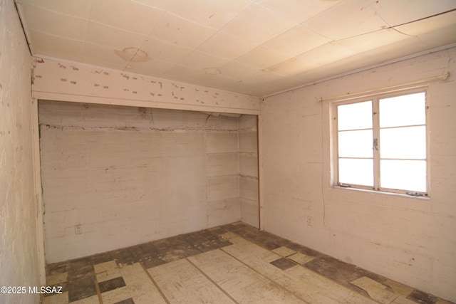 unfurnished room with concrete block wall