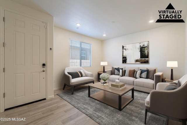 spare room with baseboards, light wood finished floors, and visible vents