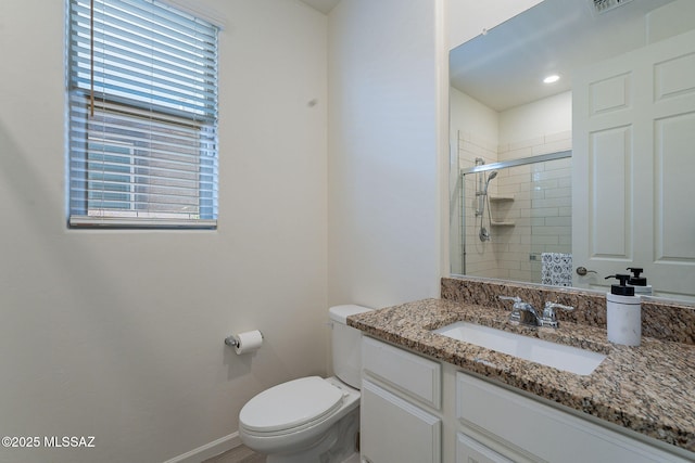 bathroom with vanity, a stall shower, a wealth of natural light, and toilet