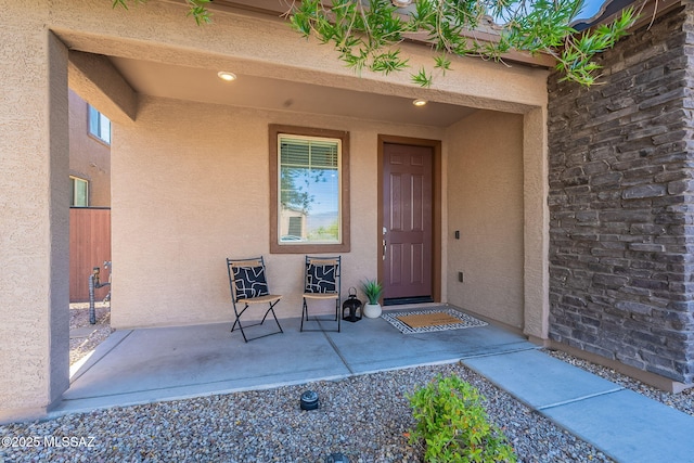 doorway to property featuring stucco siding