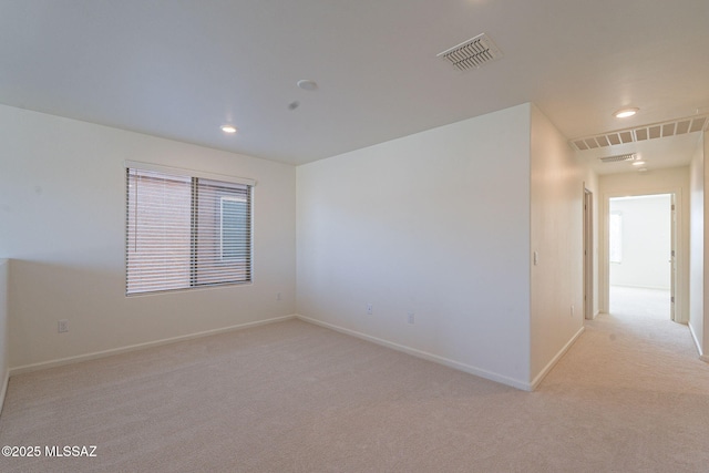 unfurnished room with recessed lighting, baseboards, visible vents, and light carpet
