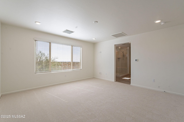 spare room featuring baseboards, light colored carpet, recessed lighting, and visible vents