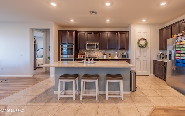 10199 S Pantano Knolls Dr, Vail, AZ 85641 - kitchen with a sink, a breakfast bar area, stainless steel appliances, and visible vents