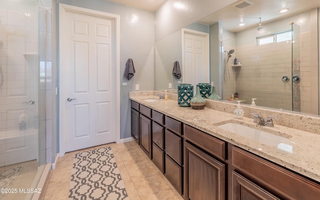 10199 S Pantano Knolls Dr, Vail, AZ 85641 - bathroom with double vanity, tiled shower, a sink, and visible vents
