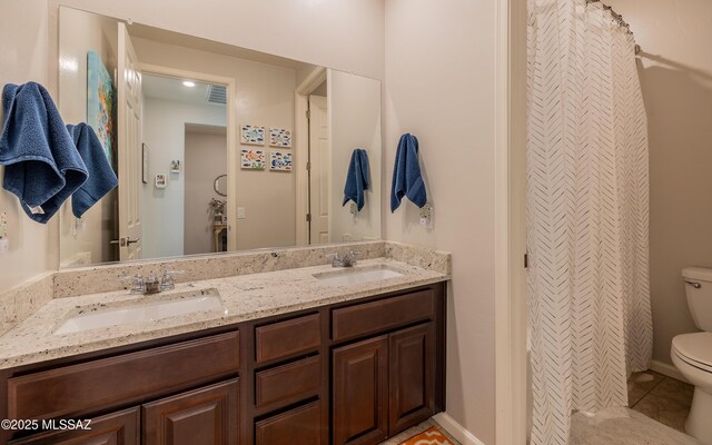 10199 S Pantano Knolls Dr, Vail, AZ 85641 - full bath with double vanity, a sink, tile patterned floors, and toilet
