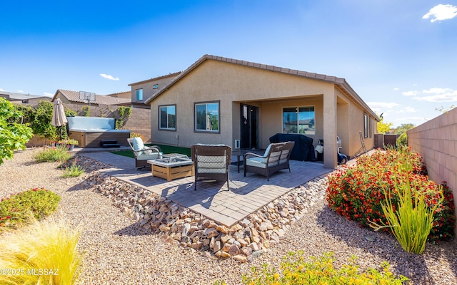 10199 S Pantano Knolls Dr, Vail, AZ 85641 - back of property featuring stucco siding, an outdoor living space with a fire pit, a hot tub, and a patio area