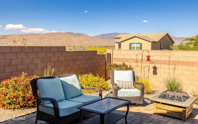 10199 S Pantano Knolls Dr, Vail, AZ 85641 - view of patio featuring fence, a mountain view, and an outdoor living space with a fire pit