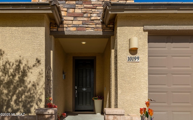 10199 S Pantano Knolls Dr, Vail, AZ 85641 - doorway to property with a garage, stucco siding, and stone siding