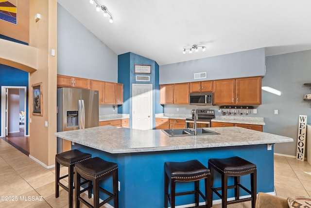 9949 N Blue Crossing Way, Tucson, AZ 85743 - kitchen featuring high vaulted ceiling, stainless steel appliances, light tile patterned floors, light countertops, and a sink