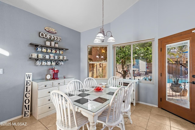 9949 N Blue Crossing Way, Tucson, AZ 85743 - dining area featuring a chandelier, light tile patterned floors, high vaulted ceiling, and baseboards