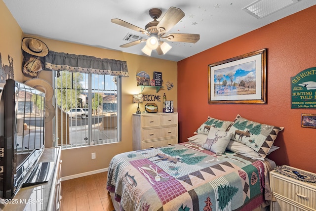 9949 N Blue Crossing Way, Tucson, AZ 85743 - bedroom featuring wood finished floors, baseboards, and ceiling fan