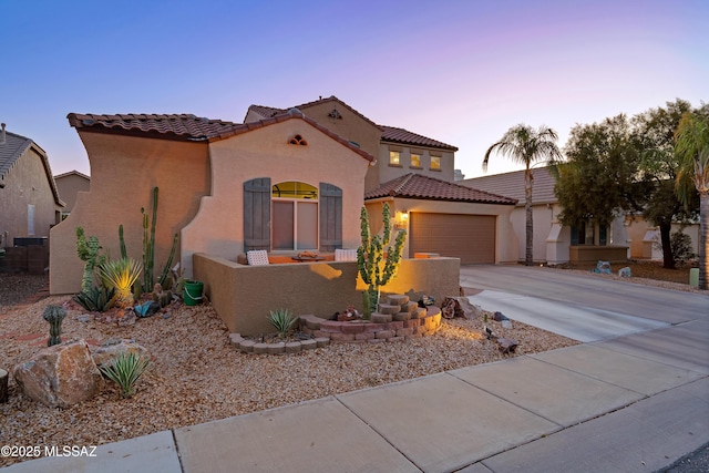 9949 N Blue Crossing Way, Tucson, AZ 85743 - mediterranean / spanish-style house with driveway, a tiled roof, stucco siding, and an attached garage