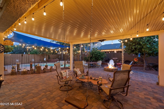 9949 N Blue Crossing Way, Tucson, AZ 85743 - patio at twilight featuring an outdoor fire pit and fence