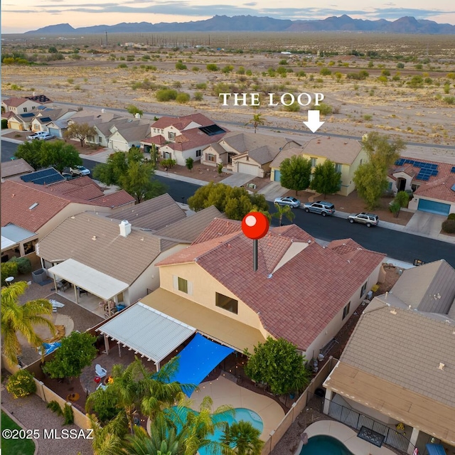 9949 N Blue Crossing Way, Tucson, AZ 85743 - aerial view at dusk of a mountain view, a residential view, and view of pool area