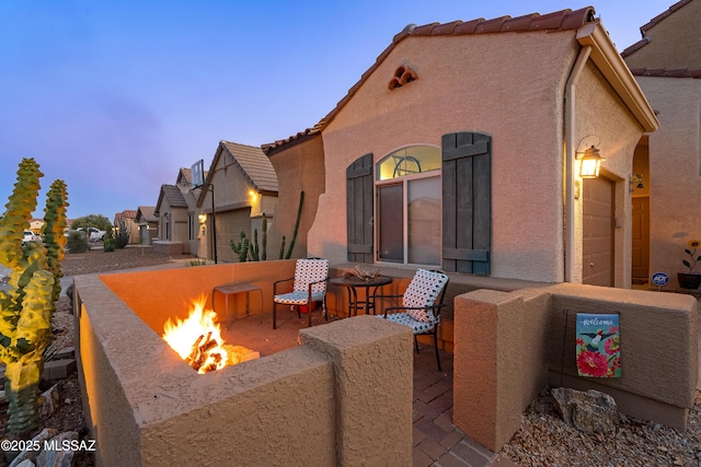 9949 N Blue Crossing Way, Tucson, AZ 85743 - view of patio / terrace featuring an outdoor fire pit