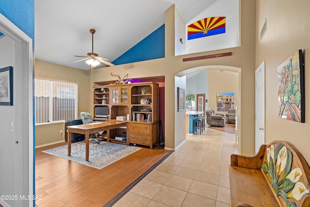 9949 N Blue Crossing Way, Tucson, AZ 85743 - office space featuring high vaulted ceiling, a ceiling fan, arched walkways, baseboards, and light tile patterned floors