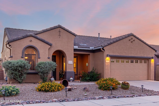 5884 S Azure Vista Way, Green Valley, AZ 85622 - mediterranean / spanish home featuring an attached garage, concrete driveway, stucco siding, and a tile roof