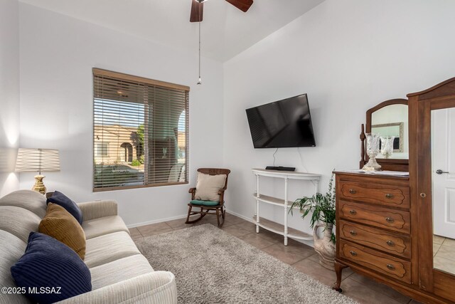 5884 S Azure Vista Way, Green Valley, AZ 85622 - living area featuring tile patterned floors, a ceiling fan, vaulted ceiling, and baseboards