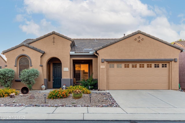 5884 S Azure Vista Way, Green Valley, AZ 85622 - mediterranean / spanish-style home featuring driveway, an attached garage, a tiled roof, and stucco siding