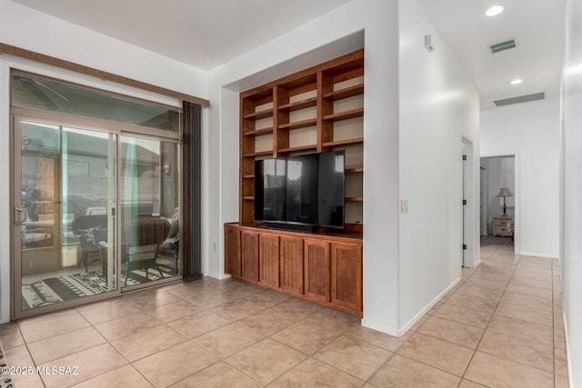 5884 S Azure Vista Way, Green Valley, AZ 85622 - unfurnished living room featuring light tile patterned flooring, built in shelves, recessed lighting, and baseboards