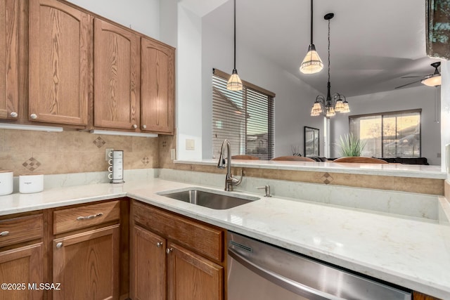 5884 S Azure Vista Way, Green Valley, AZ 85622 - kitchen featuring stainless steel dishwasher, a sink, pendant lighting, brown cabinetry, and a chandelier